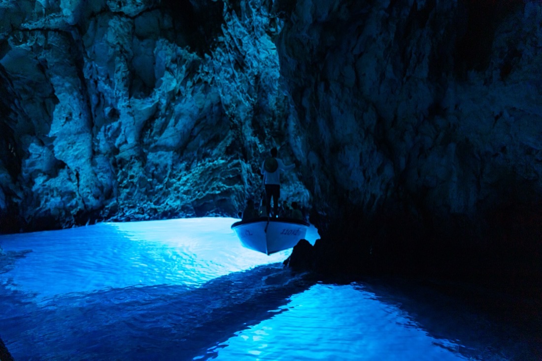 Sunlight glowing electric blue inside the Blue Cave on Koločep
